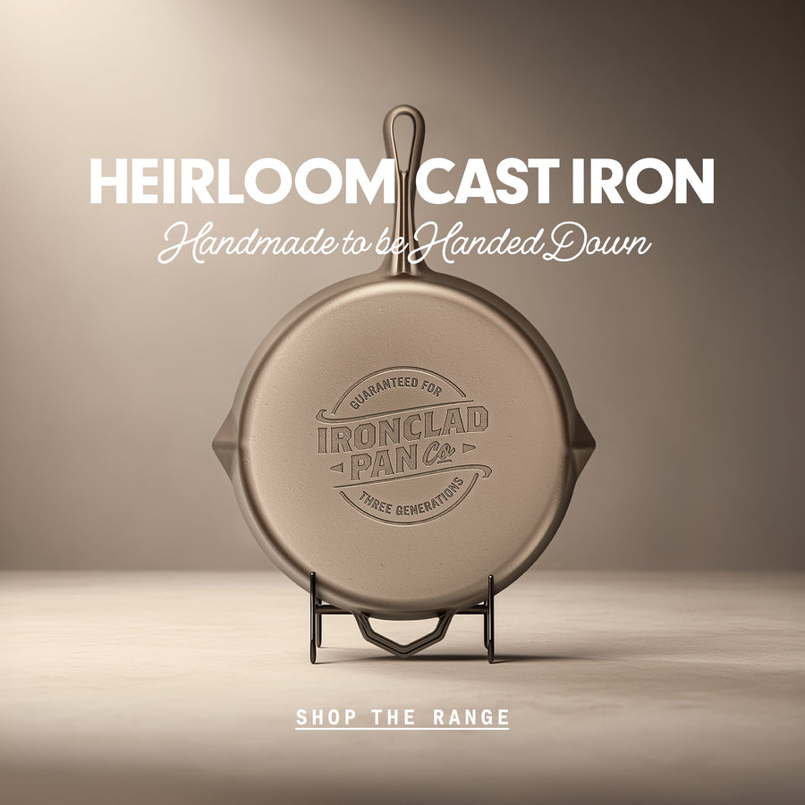 A smooth cast iron pan sits on a display. Cast into the iron is the Ironclad Three Generation Guarantee™. The text “Heirloom Cast Iron” appears at the top, with “Handmade to be Handed Down” written beneath it.