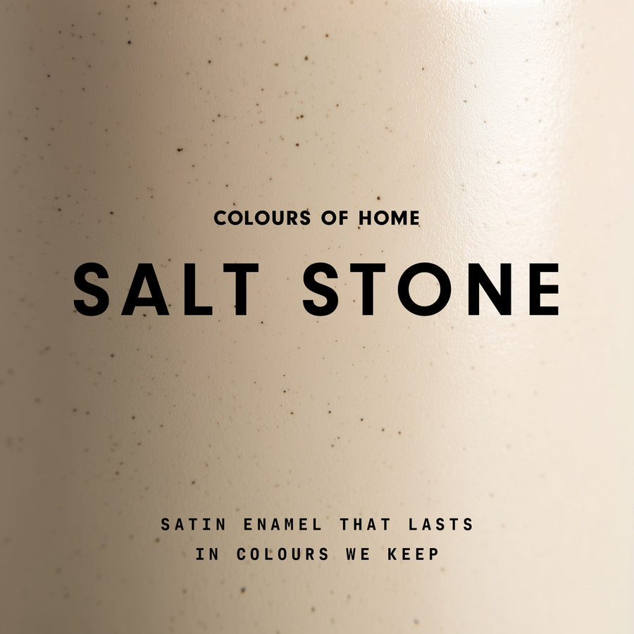 A close-up speckled stone coloured enamel surface with the words “Colours of Home” at the top, “Salt Stone” in large bold text in the centre, and “Satin enamel that lasts in colours we keep” at the bottom.